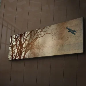 Canvastavla med LED-belysning 30x90 cm - Silhuett av träd med en fågel i flykt mot en mjukt tonad bakgrund Mörkbrun / Beige / Svart - Inredning Säker betalning