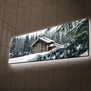 Canvastavla med LED-belysning 30x90 cm - Vinterlandskap med en stuga omgiven av snö och granar Vit / Grön / Brun - Inredning Extra rabatt