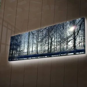 Canvastavla med LED-belysning 30x90 cm - Vinterlandskap med snöklädda träd och en svag solstråle Blå / Vit / Grå - Inredning Extra rabatt